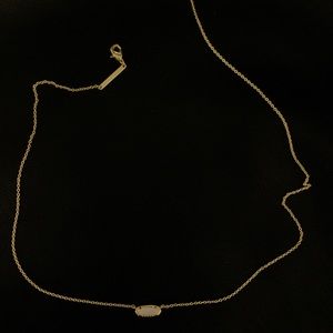 Kendra Scott gold necklace with ivory colored pendant